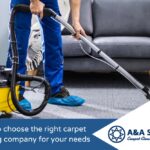 A professional carpet cleaner in a blue uniform and blue shoe covers uses a yellow and black steam cleaning machine on a grey carpet.